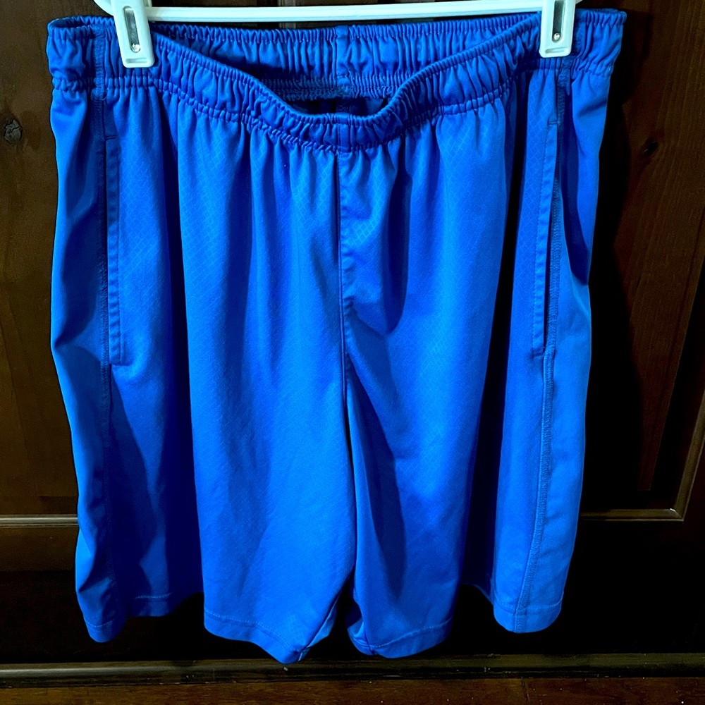Men’s medium blue Tek Gear workout shorts.